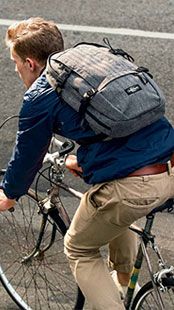 Man riding a bike with Eastpak bag